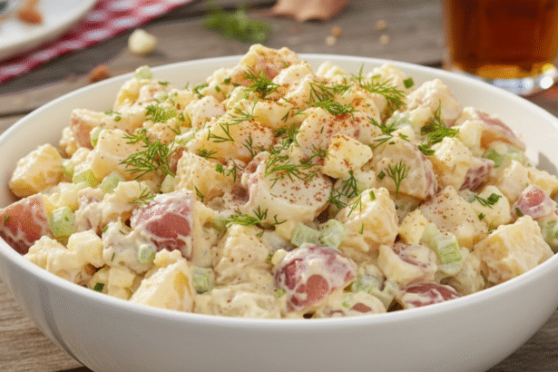 Classic potato salad recipe served with fresh herbs for summer BBQ