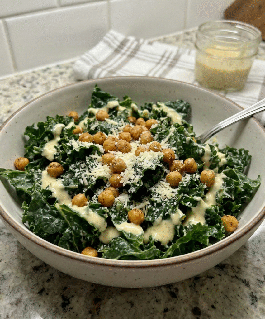 kale caesar salad bowl with roasted chickpeas, parmesan and healthy yogurt caesar dressing