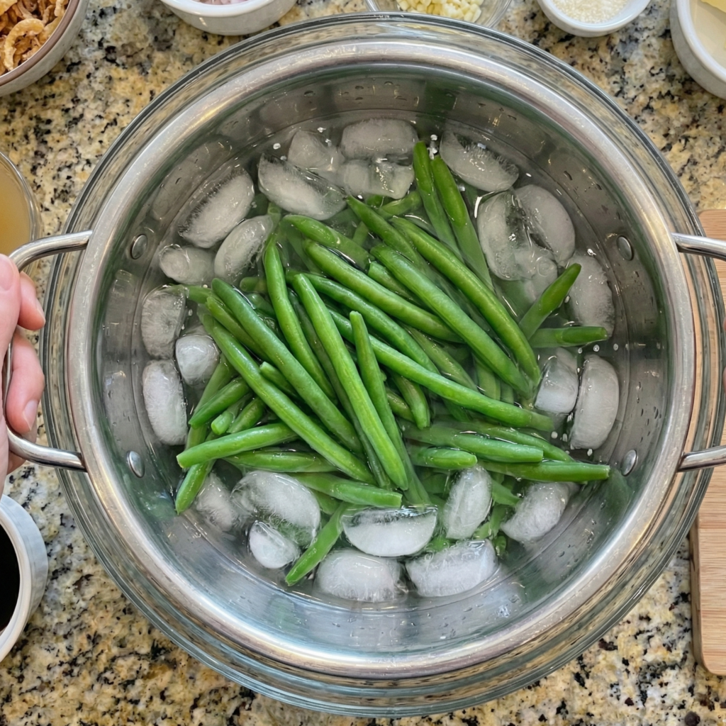 Blanched green beans in an ice water bath to keep them crisp and bright for green bean casserole