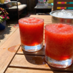 Cranberry lemon drop cocktails served in sugar-rimmed martini glasses, festive holiday cocktail drinks with fresh lemon and cranberries