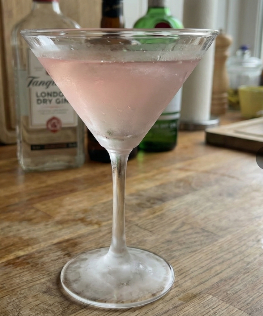 Spiced cranberry lemon drop cocktail with cinnamon garnish, warm holiday martini recipe